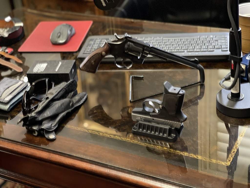 Magnetic gun mount shown with a compact pistol