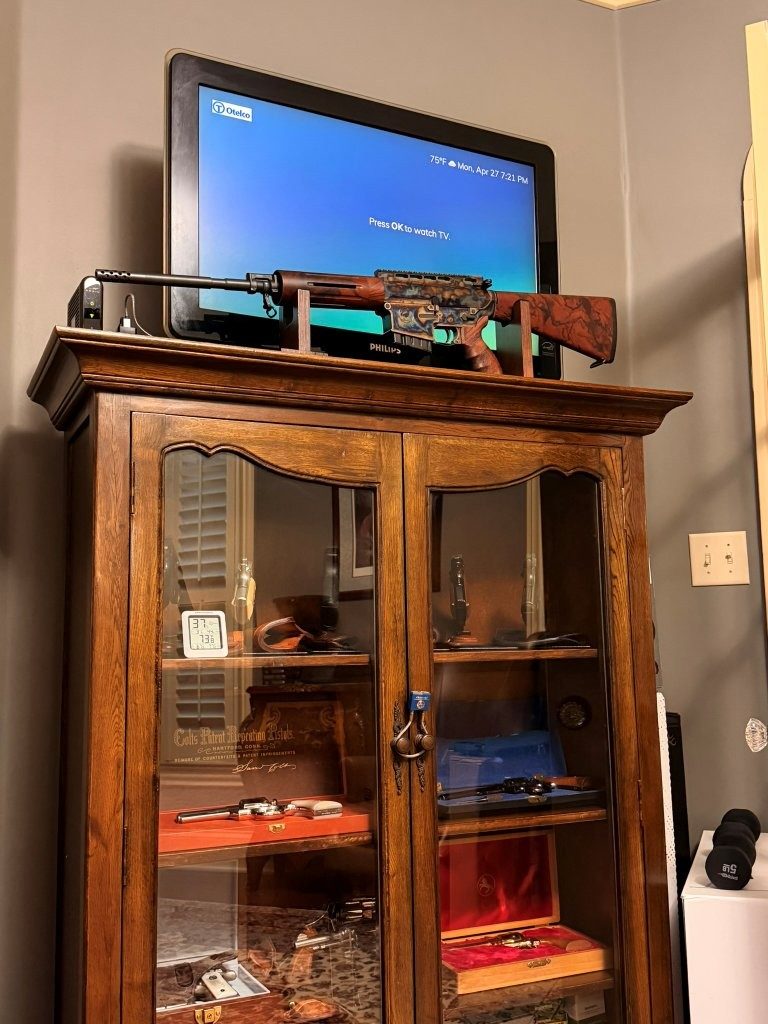 Vertical room view of the Turnbull TAR-40 displayed above a gun cabinet