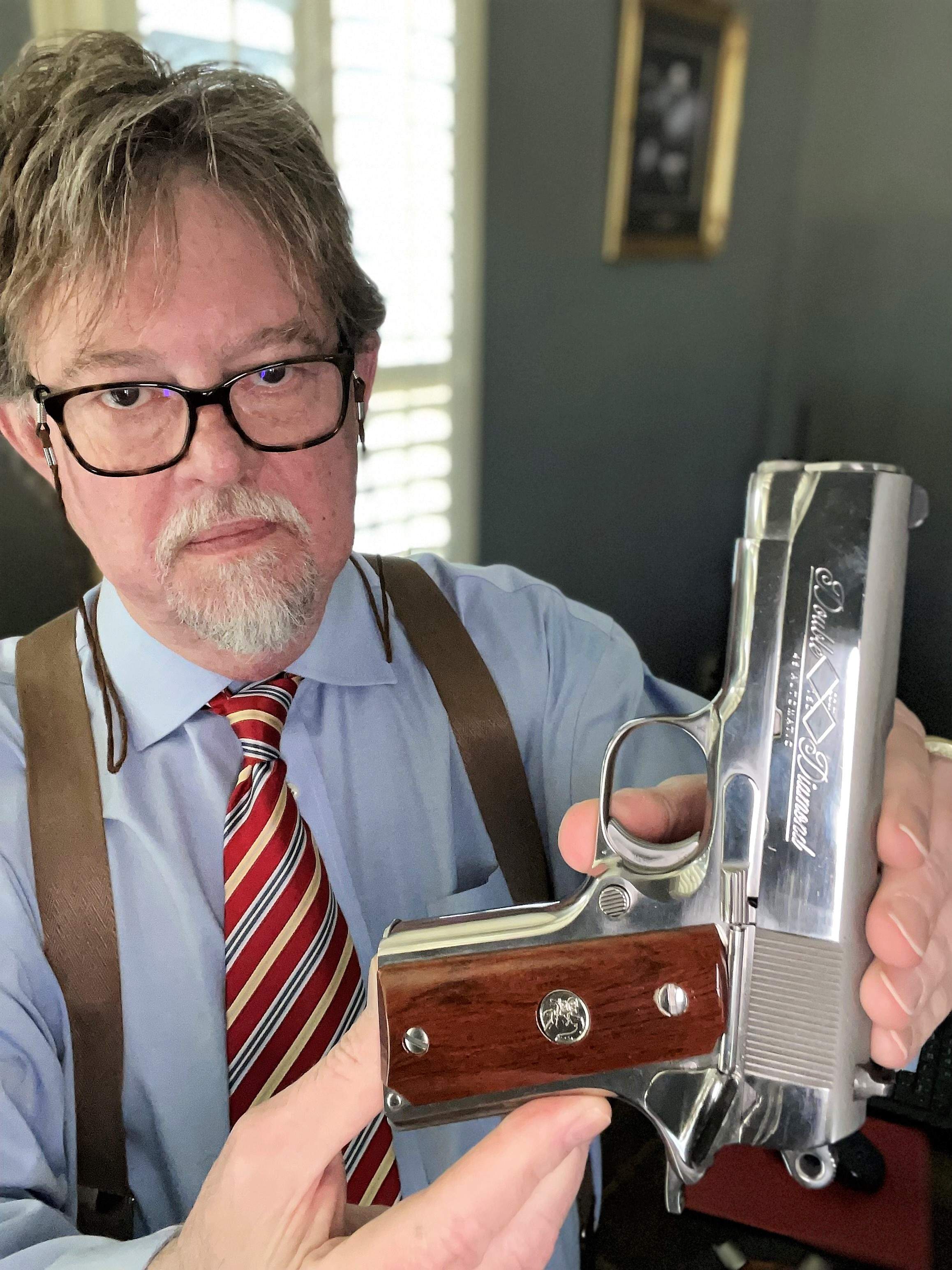 Author holding Colt Officers Model Double Diamond .45 ACP
