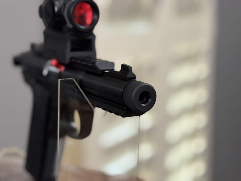 Front three-quarter view of a Ruger 22 pistol with optic