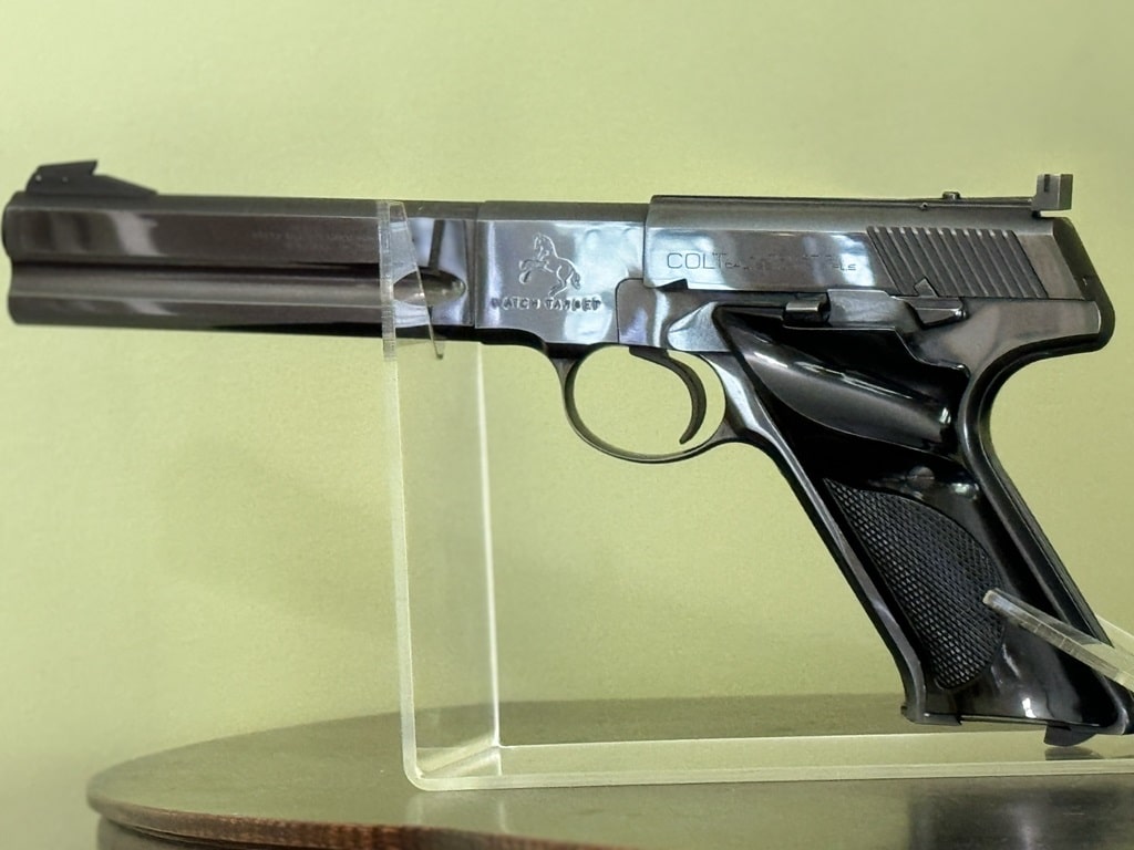 Colt Woodsman Match Target pistol and shooting accessories