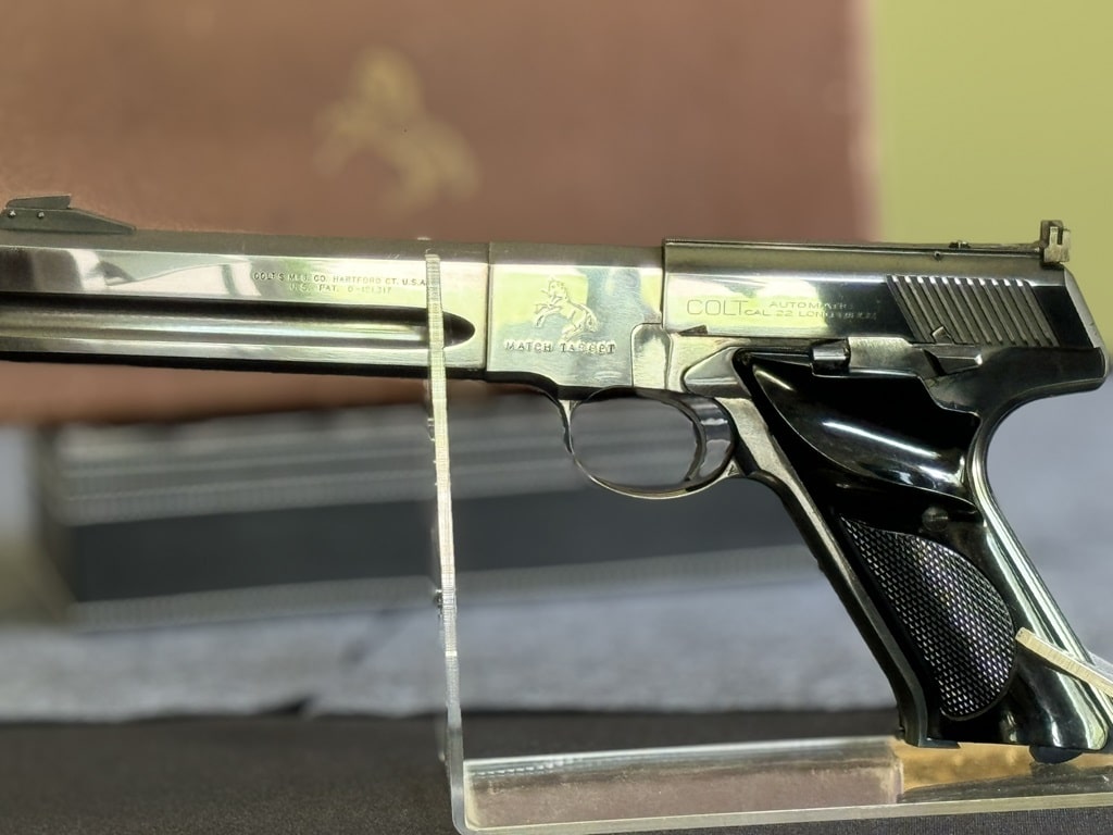 1955 Colt Woodsman Match Target pistol with target shooting accessories